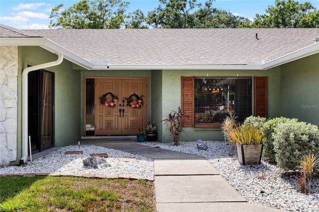 4301 Hudson Ln, Tampa, FL 33618 - property entrance featuring roof with shingles and stucco siding