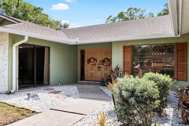 4301 Hudson Ln, Tampa, FL 33618 - entrance to property with roof with shingles and stucco siding