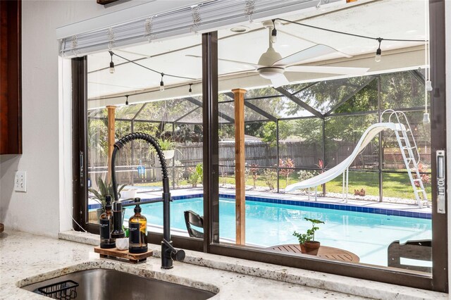 4301 Hudson Ln, Tampa, FL 33618 - view of swimming pool featuring a water slide, a sink, and ceiling fan