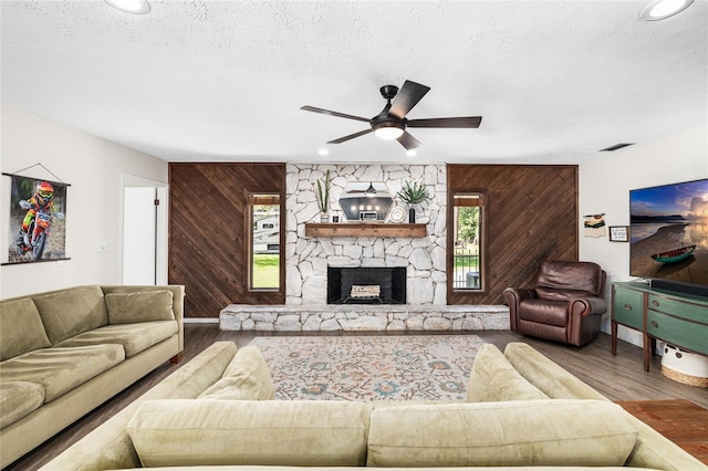4301 Hudson Ln, Tampa, FL 33618 - living room featuring wooden walls, plenty of natural light, a textured ceiling, wood finished floors, and ceiling fan