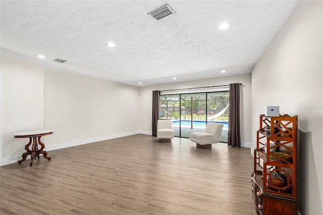 4301 Hudson Ln, Tampa, FL 33618 - unfurnished room featuring a textured ceiling, recessed lighting, wood finished floors, and baseboards
