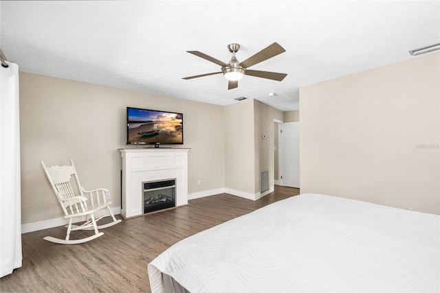4301 Hudson Ln, Tampa, FL 33618 - bedroom with wood finished floors, baseboards, and a fireplace
