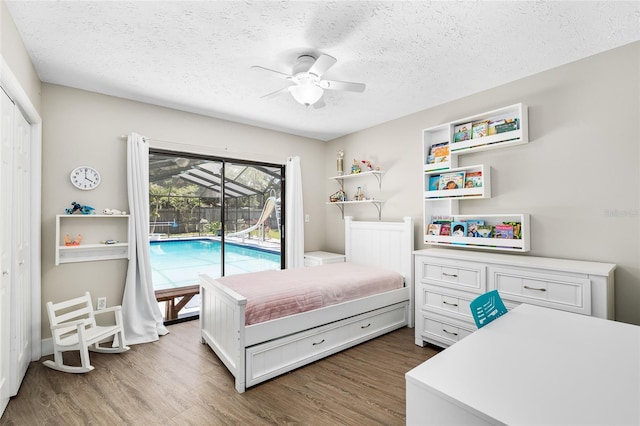 4301 Hudson Ln, Tampa, FL 33618 - bedroom with access to outside, wood finished floors, a textured ceiling, ceiling fan, and a closet