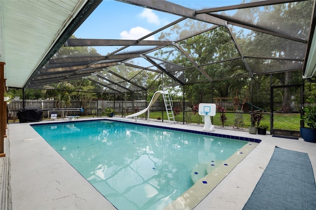 4301 Hudson Ln, Tampa, FL 33618 - view of swimming pool with a water slide, area for grilling, a fenced backyard, a playground, and glass enclosure