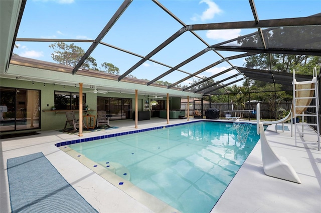 4301 Hudson Ln, Tampa, FL 33618 - view of swimming pool featuring a water slide, a patio, a ceiling fan, and a lanai