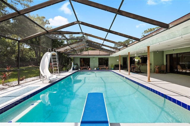 4301 Hudson Ln, Tampa, FL 33618 - outdoor pool featuring a water slide, a patio, a ceiling fan, and glass enclosure