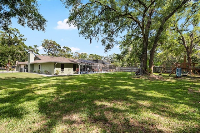 4301 Hudson Ln, Tampa, FL 33618 - view of yard featuring a playground and glass enclosure