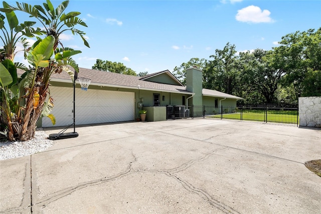 4301 Hudson Ln, Tampa, FL 33618 - ranch-style house featuring a garage, concrete driveway, and a chimney