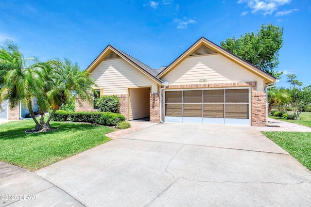 706 Fox Tail Ct, New Smyrna Beach, FL 32168 - ranch-style home featuring brick siding, a garage, driveway, and a front yard