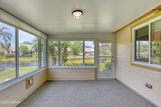 706 Fox Tail Ct, New Smyrna Beach, FL 32168 - unfurnished sunroom featuring carpet floors, wooden walls, and a water view