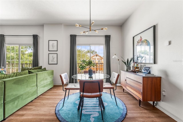 1469 Broken Oak Dr Unit 43A, Winter Garden, FL 34787 - dining room featuring a chandelier, healthy amount of natural light, and wood finished floors