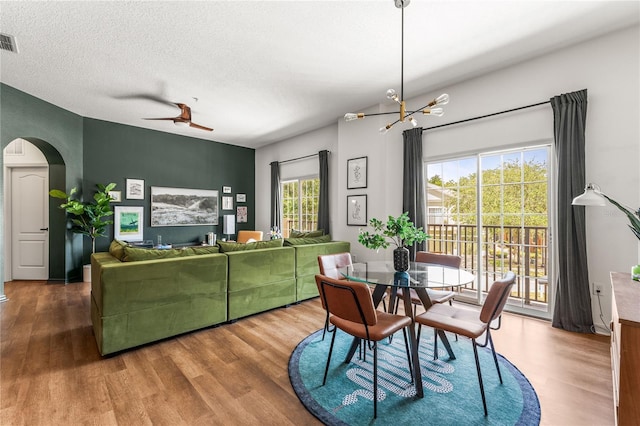 1469 Broken Oak Dr Unit 43A, Winter Garden, FL 34787 - dining room with wood finished floors, arched walkways, ceiling fan, a chandelier, and a textured ceiling