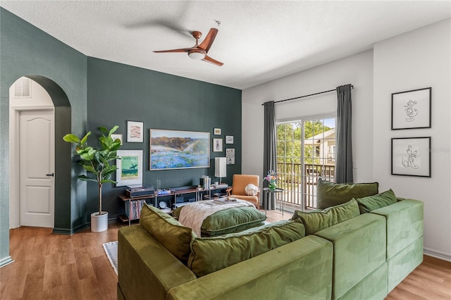 1469 Broken Oak Dr Unit 43A, Winter Garden, FL 34787 - living room with ceiling fan, arched walkways, wood finished floors, and baseboards