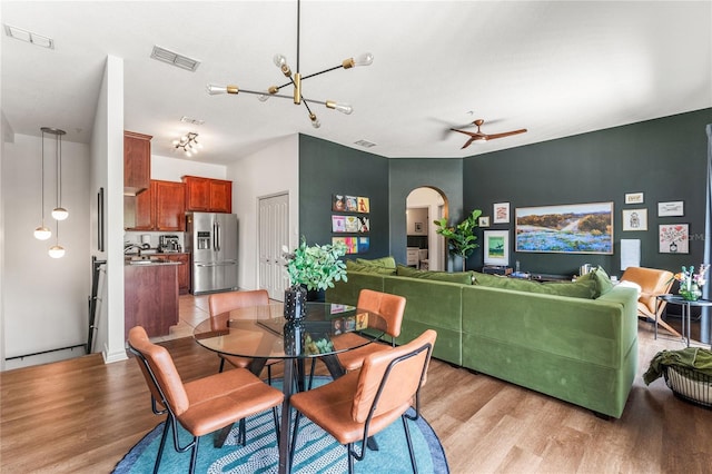 1469 Broken Oak Dr Unit 43A, Winter Garden, FL 34787 - dining space with arched walkways, light wood-type flooring, and a ceiling fan
