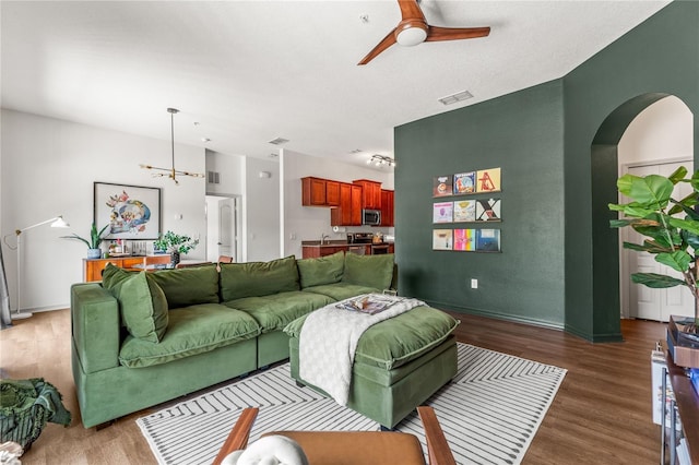 1469 Broken Oak Dr Unit 43A, Winter Garden, FL 34787 - living area featuring wood finished floors, a ceiling fan, arched walkways, and baseboards