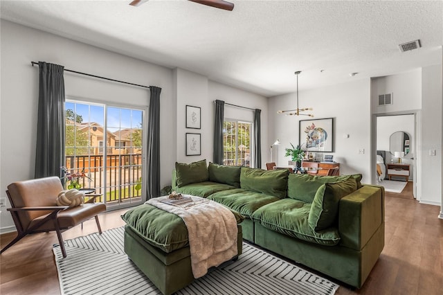 1469 Broken Oak Dr Unit 43A, Winter Garden, FL 34787 - living room featuring ceiling fan, wood finished floors, baseboards, a chandelier, and a textured ceiling