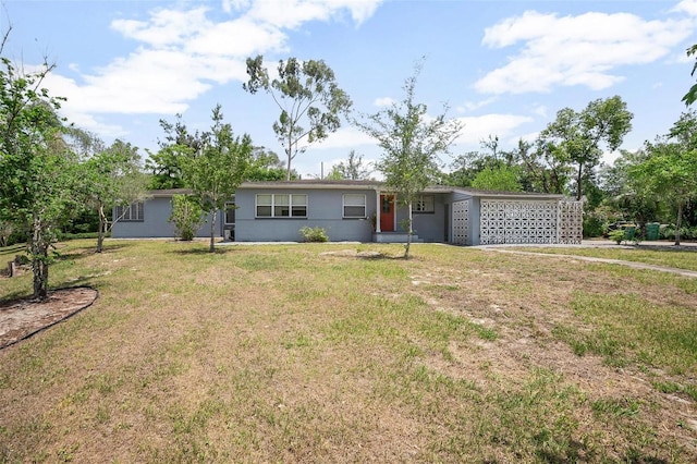 45 S University Cir, Deland, FL 32724 - single story home featuring a front lawn, a garage, driveway, and stucco siding