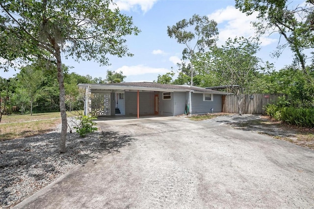 45 S University Cir, Deland, FL 32724 - ranch-style house with concrete driveway and an attached carport