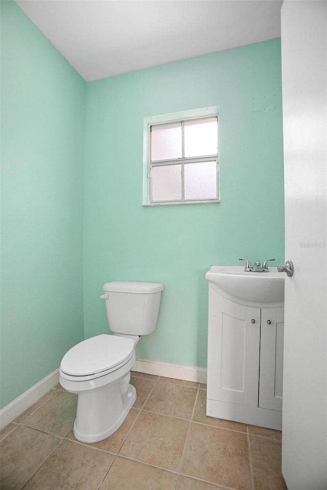 45 S University Cir, Deland, FL 32724 - bathroom with toilet, vanity, baseboards, and tile patterned flooring