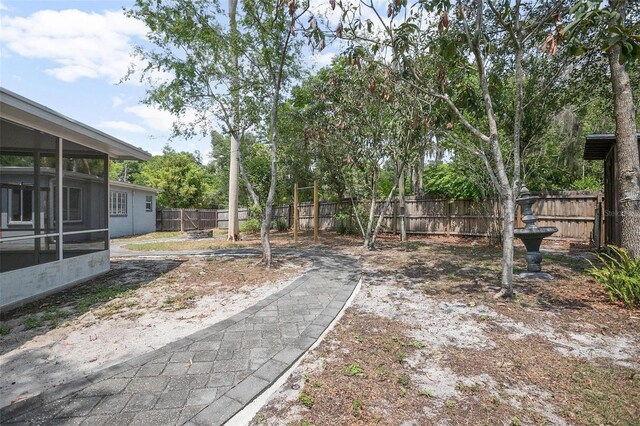 45 S University Cir, Deland, FL 32724 - fenced backyard featuring a sunroom