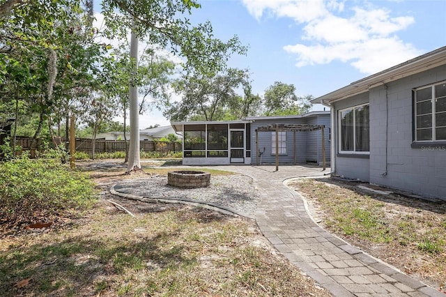 45 S University Cir, Deland, FL 32724 - view of yard featuring an outdoor fire pit, a sunroom, and a patio