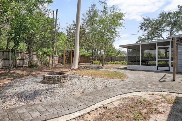 45 S University Cir, Deland, FL 32724 - fenced backyard with an outdoor fire pit, a sunroom, and a patio area