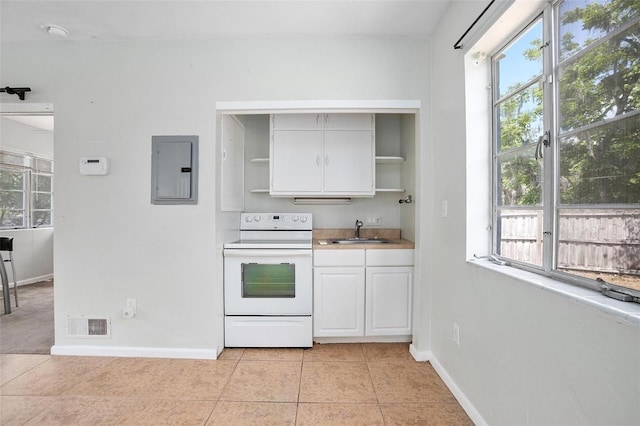 45 S University Cir, Deland, FL 32724 - kitchen with white electric range, open shelves, electric panel, a sink, and white cabinets