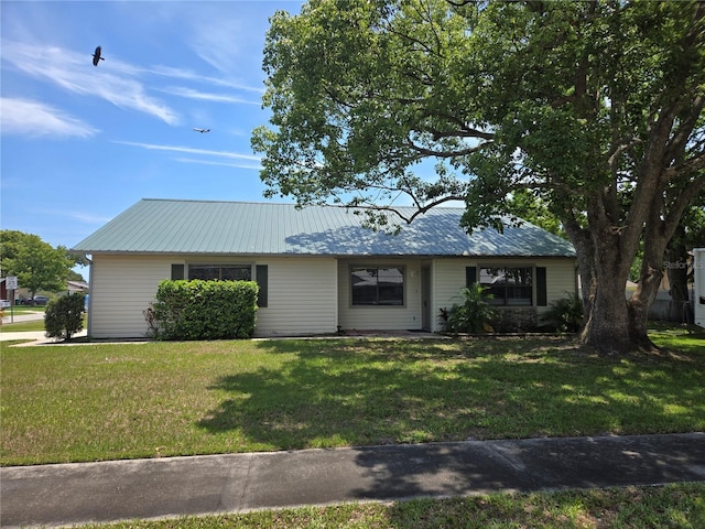 1272 Robbin Dr, Port Orange, FL 32129 - ranch-style house with a front yard and metal roof