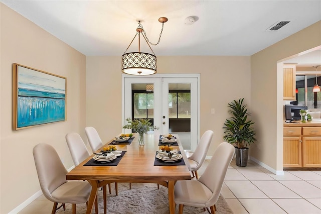 1204 Lawrence Ave, Deltona, FL 32725 - dining area with french doors, healthy amount of natural light, light tile patterned floors, and baseboards