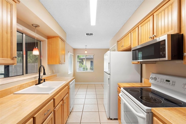 1204 Lawrence Ave, Deltona, FL 32725 - kitchen featuring white appliances, a sink, butcher block counters, and pendant lighting