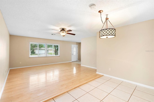 1204 Lawrence Ave, Deltona, FL 32725 - spare room with ceiling fan, a textured ceiling, light wood-style flooring, baseboards, and a smoke detector