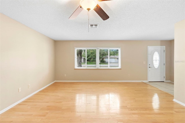 1204 Lawrence Ave, Deltona, FL 32725 - foyer entrance featuring light wood-type flooring, ceiling fan, a textured ceiling, and baseboards