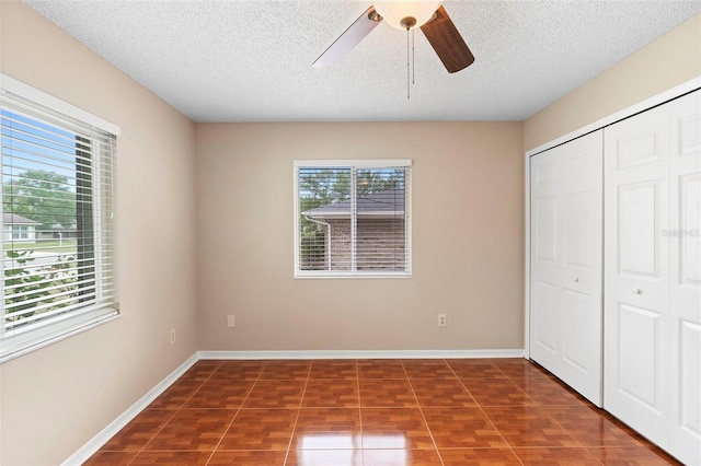 1204 Lawrence Ave, Deltona, FL 32725 - unfurnished bedroom with a closet, a textured ceiling, ceiling fan, and baseboards