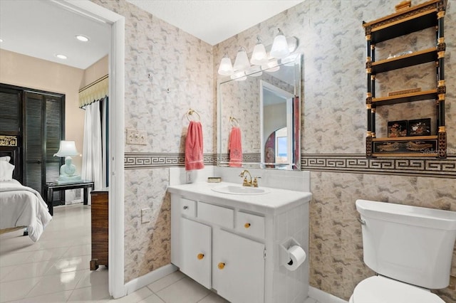915 Ocean Shore Blvd Unit 8010, Ormond Beach, FL 32176 - ensuite bathroom with vanity, toilet, tile patterned floors, and baseboards