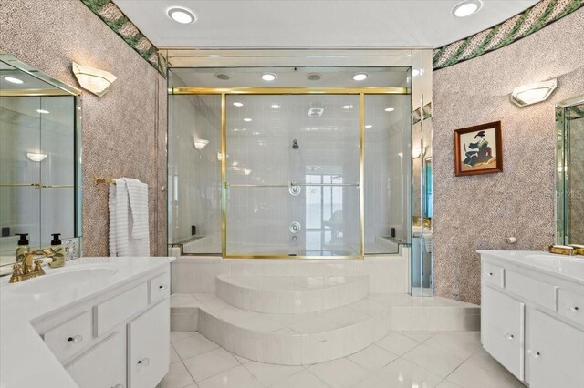 915 Ocean Shore Blvd Unit 8010, Ormond Beach, FL 32176 - full bathroom featuring two vanities, a shower with shower door, tile patterned floors, a tub, and recessed lighting