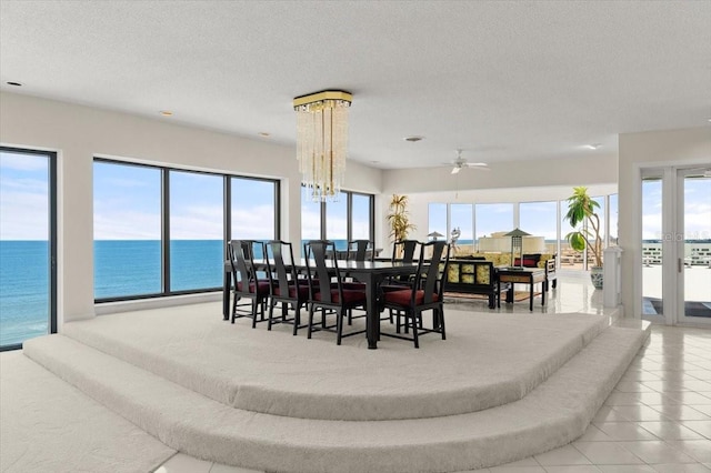915 Ocean Shore Blvd Unit 8010, Ormond Beach, FL 32176 - tiled dining space with a textured ceiling, ceiling fan, and a water view