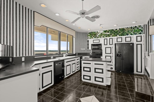 915 Ocean Shore Blvd Unit 8010, Ormond Beach, FL 32176 - kitchen featuring black appliances, dark countertops, wallpapered walls, a sink, and a ceiling fan