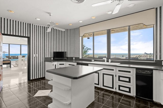 915 Ocean Shore Blvd Unit 8010, Ormond Beach, FL 32176 - kitchen with a ceiling fan, a sink, dark countertops, healthy amount of natural light, and wallpapered walls