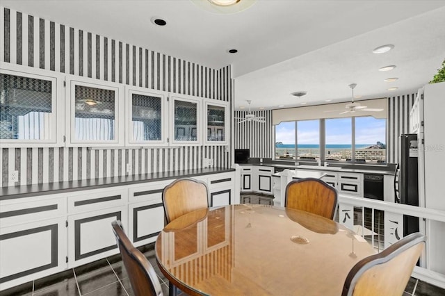 915 Ocean Shore Blvd Unit 8010, Ormond Beach, FL 32176 - dining area with dark tile patterned floors, recessed lighting, wallpapered walls, a water view, and a ceiling fan