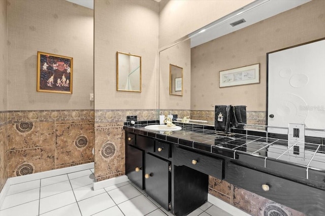 915 Ocean Shore Blvd Unit 8010, Ormond Beach, FL 32176 - bathroom featuring tile patterned floors, vanity, wainscoting, and tile walls