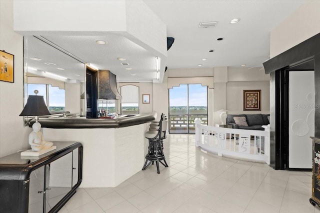 915 Ocean Shore Blvd Unit 8010, Ormond Beach, FL 32176 - kitchen featuring healthy amount of natural light, open floor plan, a breakfast bar, recessed lighting, and dark countertops