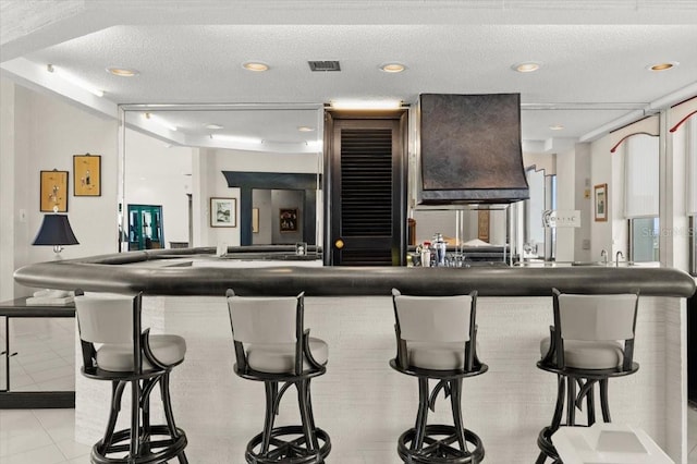 915 Ocean Shore Blvd Unit 8010, Ormond Beach, FL 32176 - bar area featuring light tile patterned floors, recessed lighting, and a textured ceiling