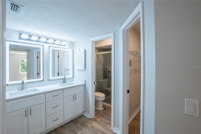 15 Misners Trl, Ormond Beach, FL 32174 - bathroom with a stall shower, double vanity, a spacious closet, and wood tiled floors