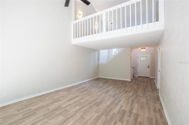 15 Misners Trl, Ormond Beach, FL 32174 - unfurnished living room with ceiling fan, wood finished floors, and a towering ceiling