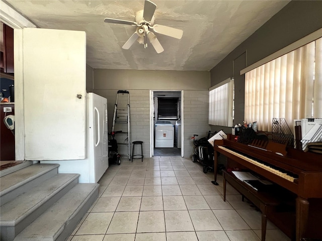 601 Berkshire Rd, Daytona Beach, FL 32114 - foyer entrance with washer / dryer, light tile patterned floors, and a ceiling fan