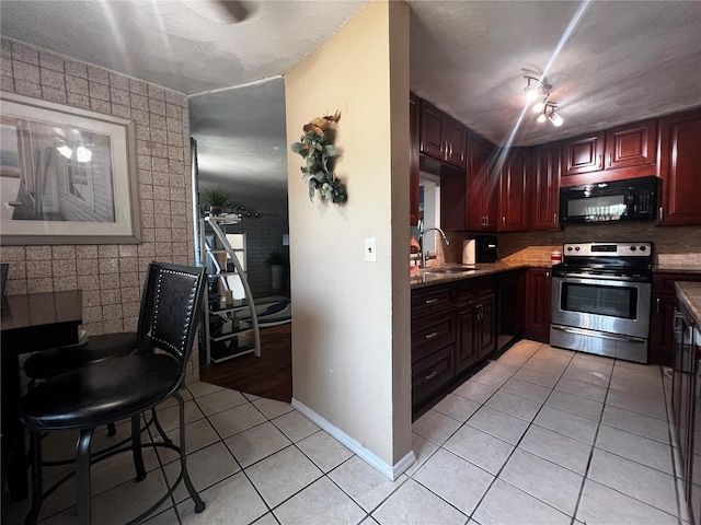 601 Berkshire Rd, Daytona Beach, FL 32114 - kitchen featuring black microwave, electric stove, light tile patterned floors, a sink, and tasteful backsplash