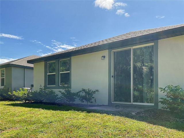 112 Lost Ball Dr, Daytona Beach, FL 32124 - view of property exterior featuring stucco siding and a lawn