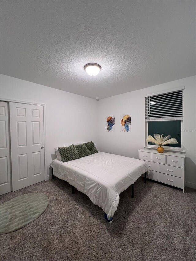 112 Lost Ball Dr, Daytona Beach, FL 32124 - carpeted bedroom featuring a closet and a textured ceiling