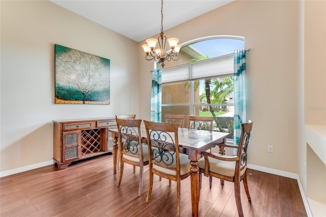 1910 Creekwater Blvd, Port Orange, FL 32128 - dining area with a chandelier, wood finished floors, baseboards, and vaulted ceiling