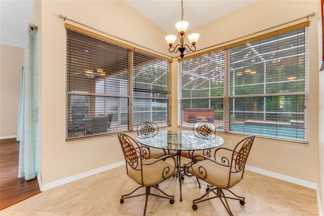 1910 Creekwater Blvd, Port Orange, FL 32128 - dining area featuring a chandelier, baseboards, and vaulted ceiling